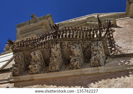 Italy, Sicily, Ragusa Ibla, the baroque facade of Cosentini Palace (Unesco monument), ornamental statues under a balcony