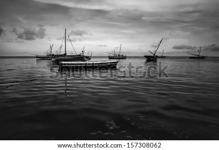 Kenya, Malindi, local fishing boats in shallow water with low tide after sunset (FILM SCAN)