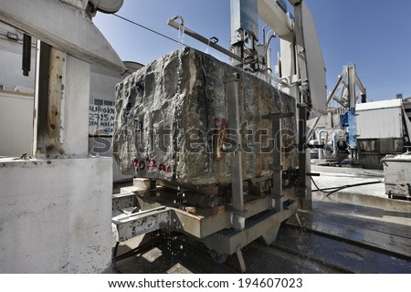 Italy, marble factory, marble cooled with water while being cut - industrial