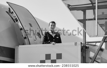 Italy, Sardinia, Olbia International Airport, flight stewardess boarding on an airplane