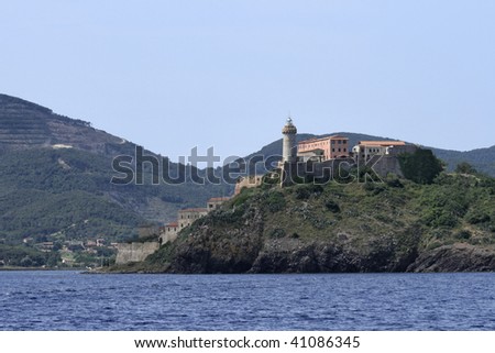 Italy, Tuscany, Elba island, view of the northern coastline and a lighthouse from the sea