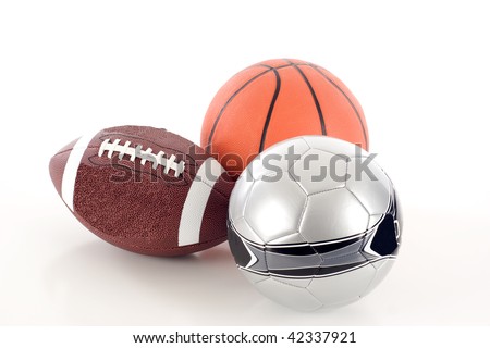A Group of Sports Balls - an American Football, Soccer Ball, and Basketball - Isolated over a white background