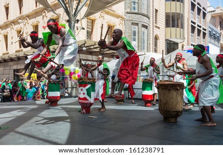 ADELAIDE, AUSTRALIA - NOVEMBER 3: Burundian Drummers Club dancers dressed in the traditional dresses perform at  Adelaide Multicultural Festival on November 3, 2013 in Rundle Mall, Adelaide, Australia.