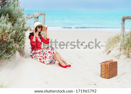 beautiful lady in red  sitting near the sea in retro style