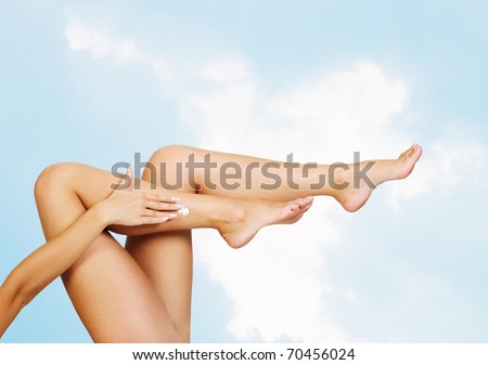 Long pretty woman legs with moisturizer body cream