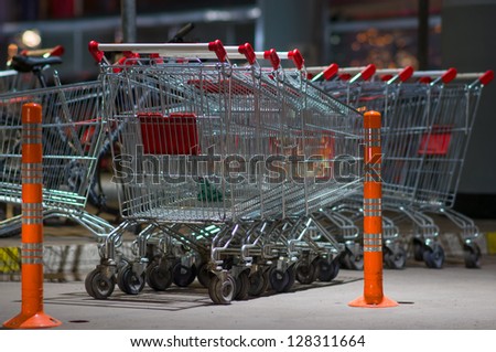 Row of shopping carts on car park at supermarket entrance
