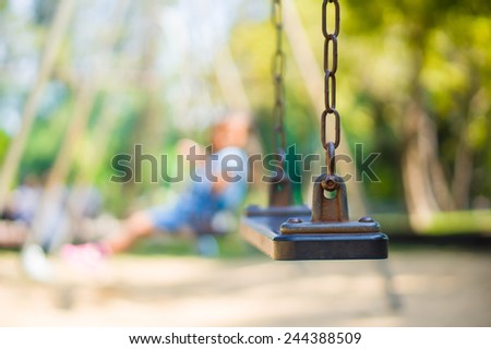 Set of chain swings on modern kids playground, kids swinging on back