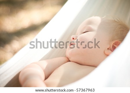 Baby sleeps quietly in hammock