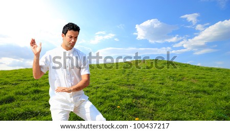 Man in white cloth in the morning meditating at hill background