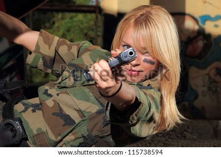 Beautiful sexy blond woman with gun