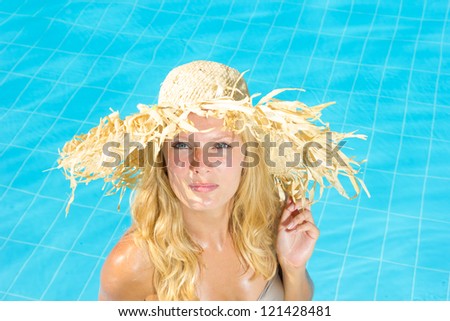 Young woman swimming underwater in the pool