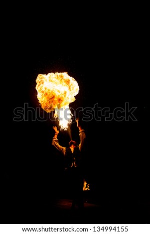Street Performer Fire Breather Blowing on Torch
