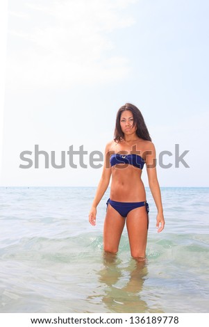 Beautiful young asian woman in bikini on the beach