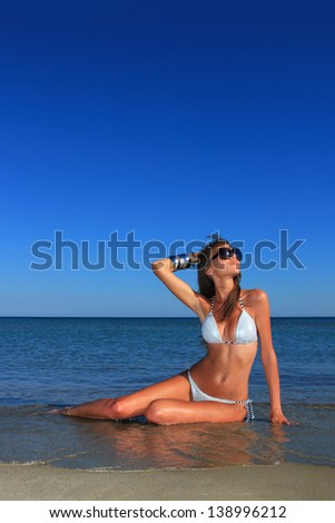 Beautiful young woman relaxing on the beach in Greece