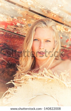 portrait of sexy blonde woman posing at shipwreck