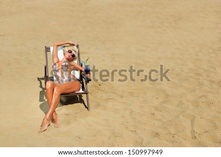 Beautiful blonde woman in bikini on the beach