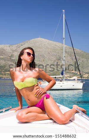 Young sexy woman a speed boat at sea