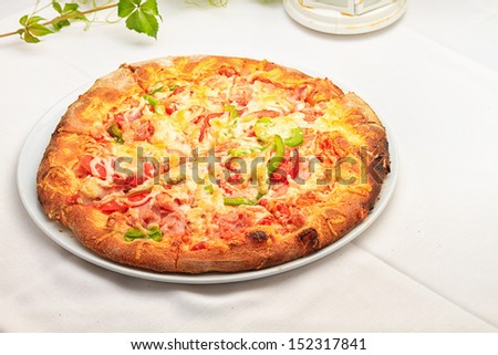 Pizza with Mozzarella Cheese, Fresh Tomato  Served at Restaurant Table