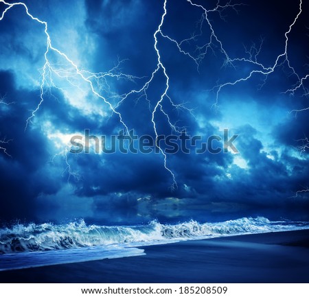 Lightning flashes across the beach from a powerful storm 商業照片 © 