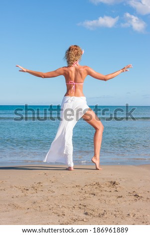 Young woman with white pants on the beach