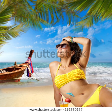 Beautiful woman on the beach in Thailand with long tailed boat on background