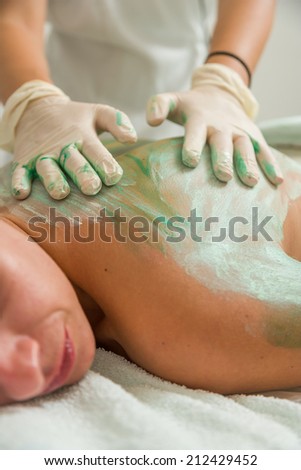 Beautiful Woman Receiving A Mud Therapy