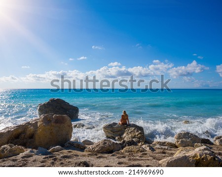 Woman looking at the beach in Kathisma Lefkada Greece