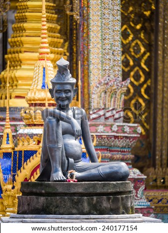 sitting figure on a stone capital in the Grand Palace, Bangkok Thailand