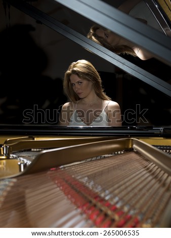 Female pianist performing on a grand concert piano
