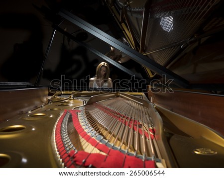 Female pianist performing on a grand concert piano