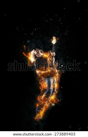 Hard rock heavy metal guitarist on fire playing his instrument