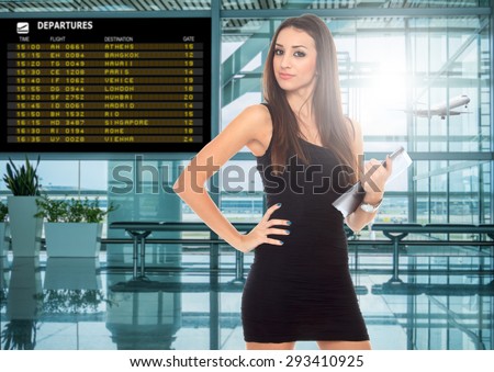 happy young woman using tablet computer at airport terminal