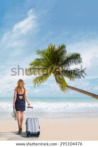 Woman with suitcase on the tropical beach