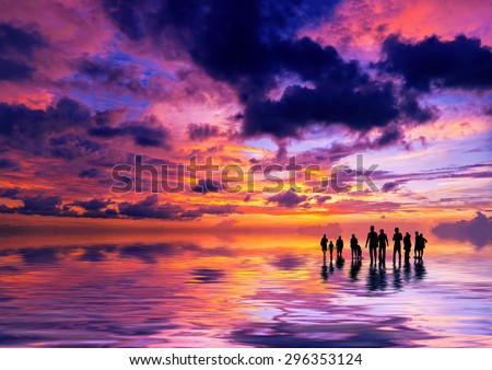 Silhouettes of people at sunset on the beach of Kuta Bali Indonesia
