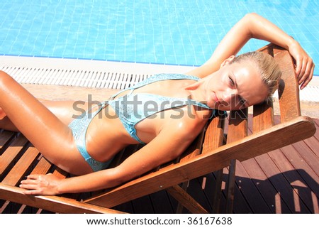 Pretty woman enjoying a swimming pool in Greece