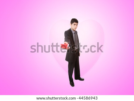 a handsome young man in suit with heart shaped gift