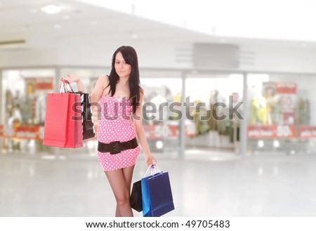 Close-up of young woman with shopping bags  in the shopping mall