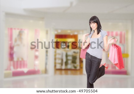 Close-up of young woman with shopping bags  in the shopping mall