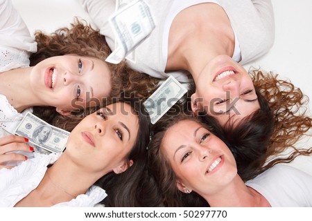 Group of happy pretty laughing girls with money over white background