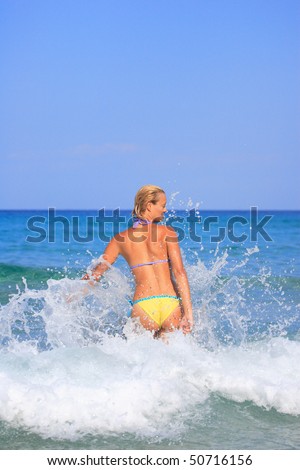 Energetic and satisfied woman on the beach in Greece