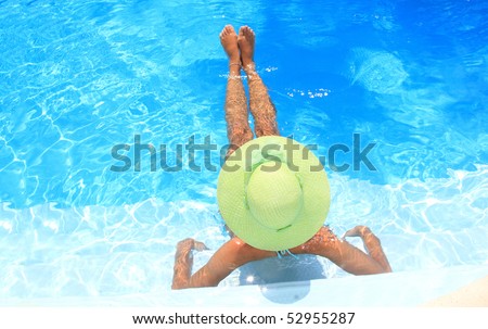 Pretty blonde woman enjoying a swimming pool in Greece