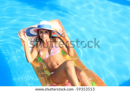 Young woman in the pool in greece