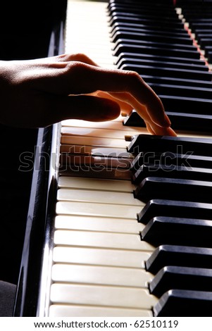 A  young woman playing piano closeup