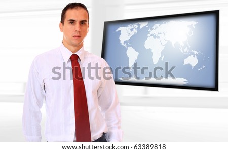 Happy business man presenting with world map on flat screen TV - Globalisation