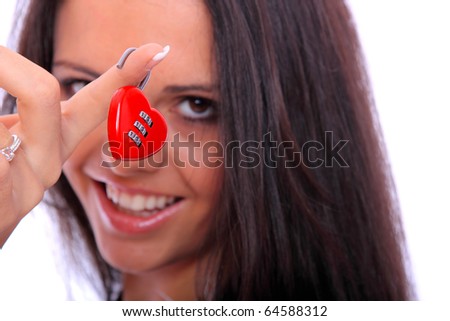Portrait of a beautiful young woman lholding a red heart shaped lock isolated over white background