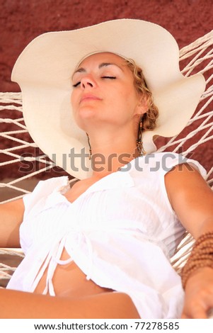 Woman sitting on sun bed in the summertime