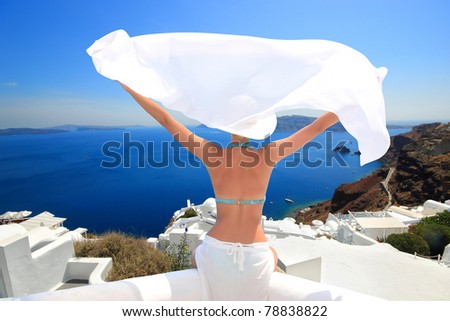 Young woman enjoying the view of  Santorini island Greece