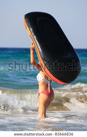 woman with inflatable boat in the sea