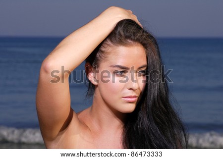 Beautiful young and happy  woman relaxing on the beach in Greece