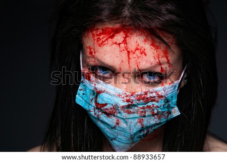 Young nurse in mask covered of blood